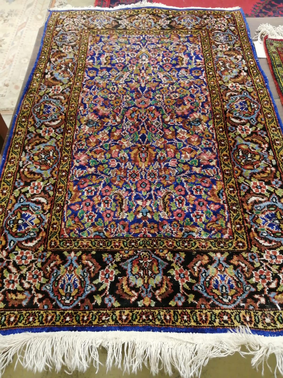 A North West Persian part silk blue ground rug, 89cm x 58cm